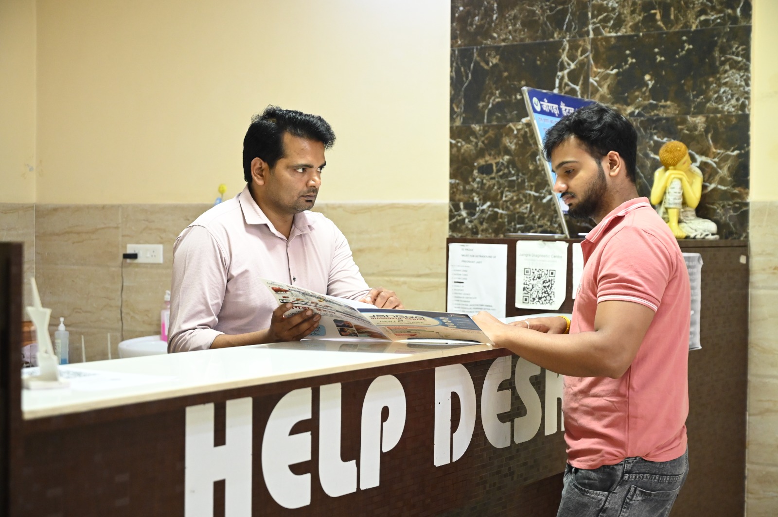 Help desk coordinator assisting a patient with test packages and brochure